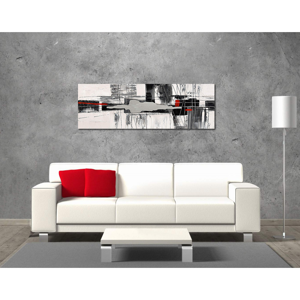 Ambiente living moderno decorato con quadro materico raffigurante soggetto astratto con elementi in rilievo