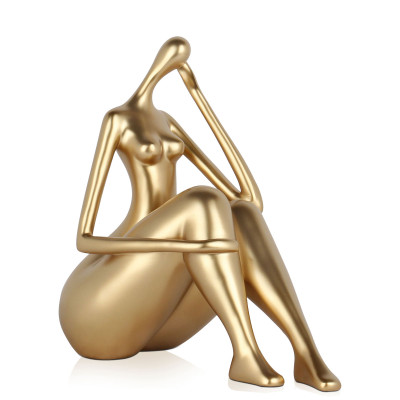 Statuetta moderna dal design minimal raffigurante una donna seduta in posa riflessiva color oro