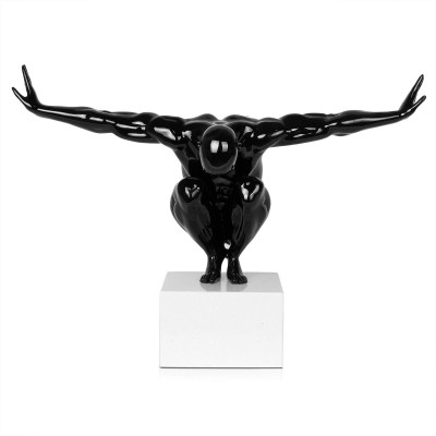 Statuetta di uomo nero accovacciato a braccia divaricate
